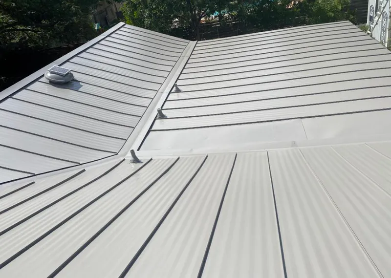 Solar attic fan installed on a metal roof for Roof Ventilation in Astoria